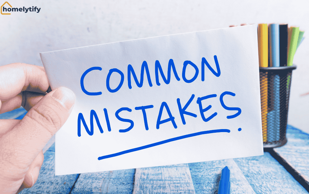 Hand holding a card with Common Mistakes written on it to avoid common mistakes in budget home organization.