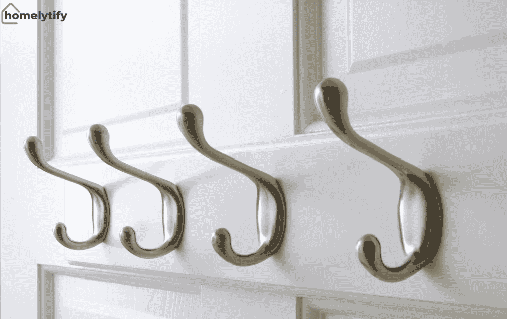 Hooks behind the door for hanging daily use items — a simple small bedroom organization idea on a budget.
