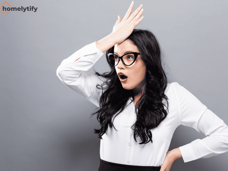 A stressed woman with a shocked expression, representing common morning routine mistakes busy people make