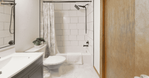 Small bathroom organization in a renter-friendly apartment with clean white vanity, subway tile shower and minimal counter clutter.