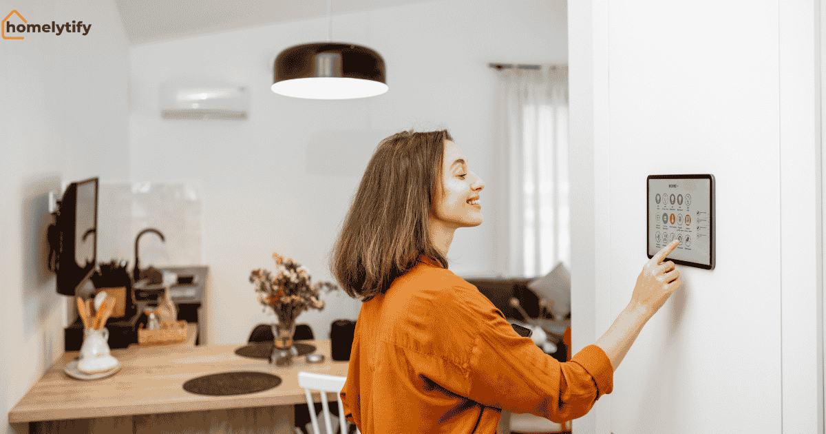 A woman using a smart home device control panel in a modern kitchen to manage lighting and home automation settings.