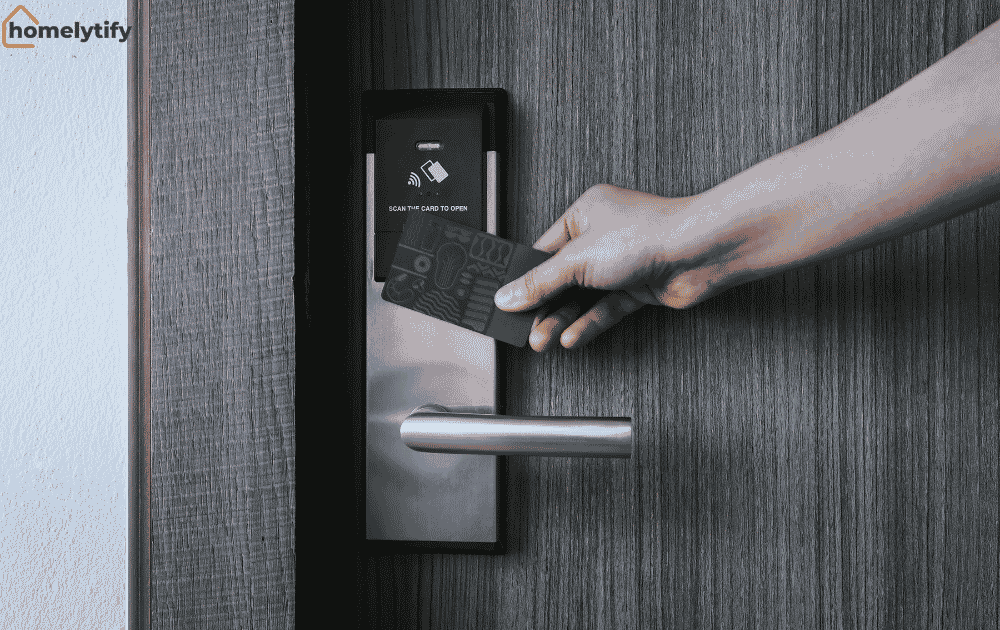Hand scanning a card on a smart lock keypad to unlock a wooden door at home