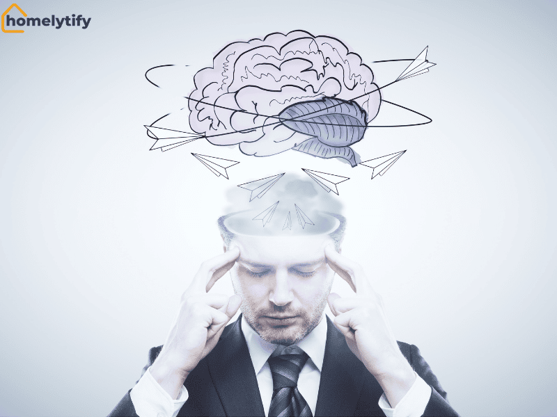 A man in a suit pressing his temples with thoughts flying out of his open mind, illustrating a 10-minute brain dump to clear mental clutter.