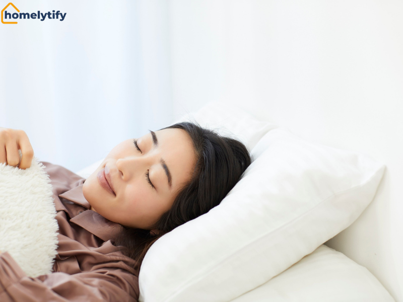 A woman sleeping peacefully in bed after choosing to end with a mental offload before sleep