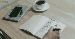 Person filling out a bullet journal habit tracker at a desk — evening routine habits for busy people.