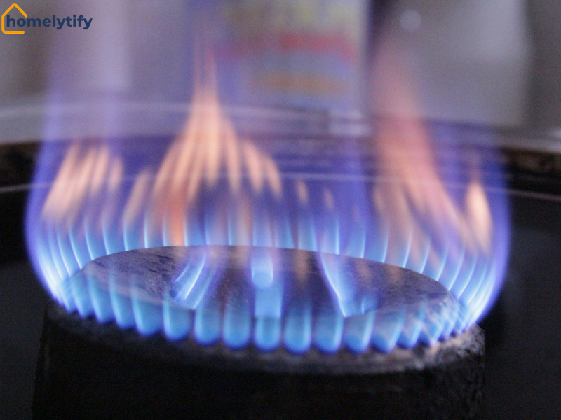 Blue flame burning on a gas stove, representing gas and heating costs in household utility bills