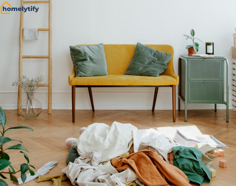 Kids' closets get messy with clothes scattered on the floor near a yellow sofa.