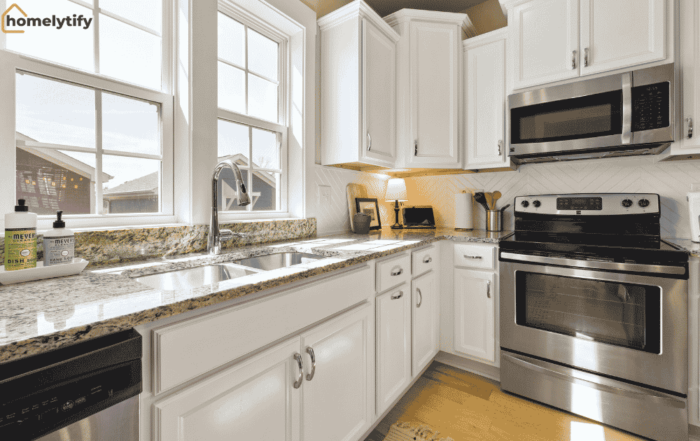 Organized a small kitchen with white cabinets and clutter-free counters, demonstrating budget kitchen hacks that create space in a small home