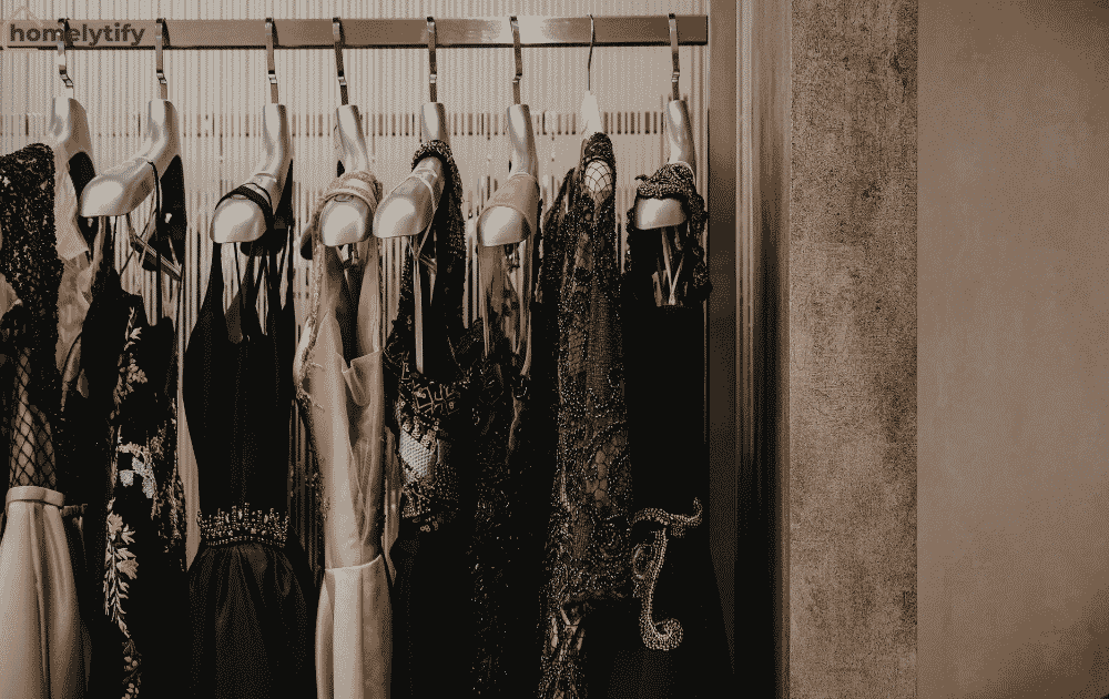 Elegant dresses hanging on a wall-mounted rail — a smart way to store clothes in a small room without a wardrobe