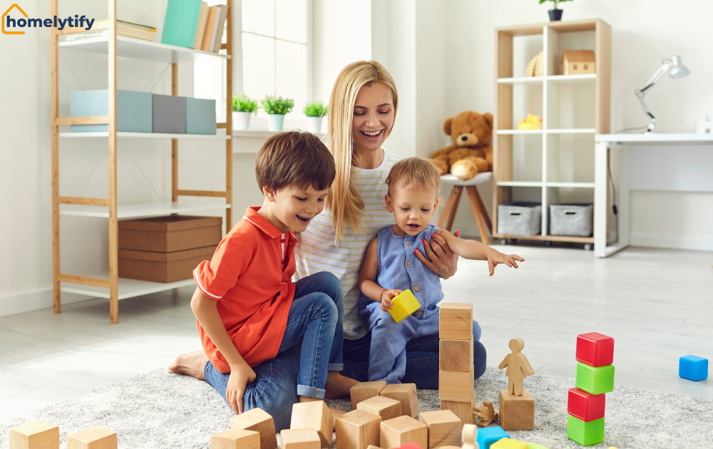 Mom and two kids are playing with wooden blocks in an organized playroom using a toy rotation system with shelves in the background.