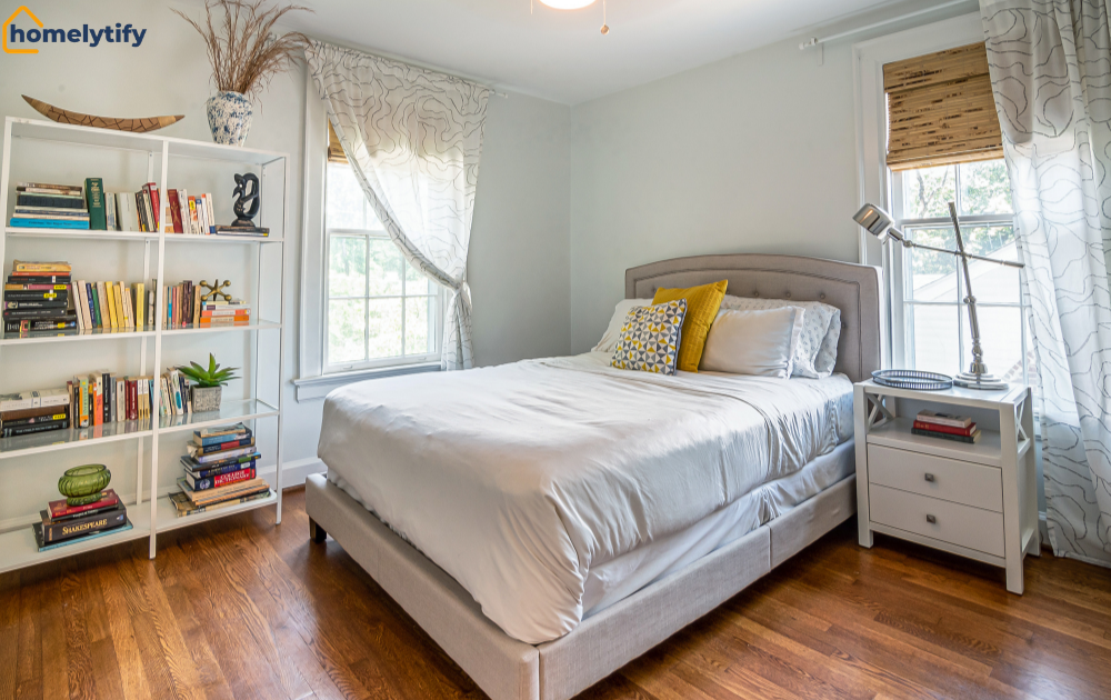 Bedroom organized with a tall bookshelf to maximize vertical space for storage, books, and decorative items 