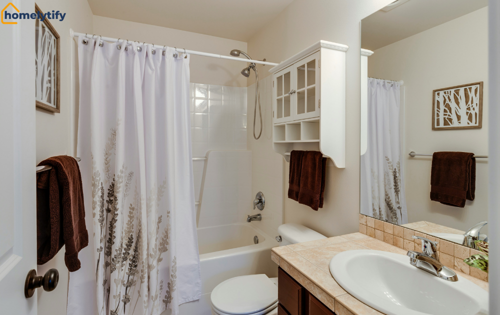 Bathrooms without cabinets using an above-toilet shelf and towel bar for storage