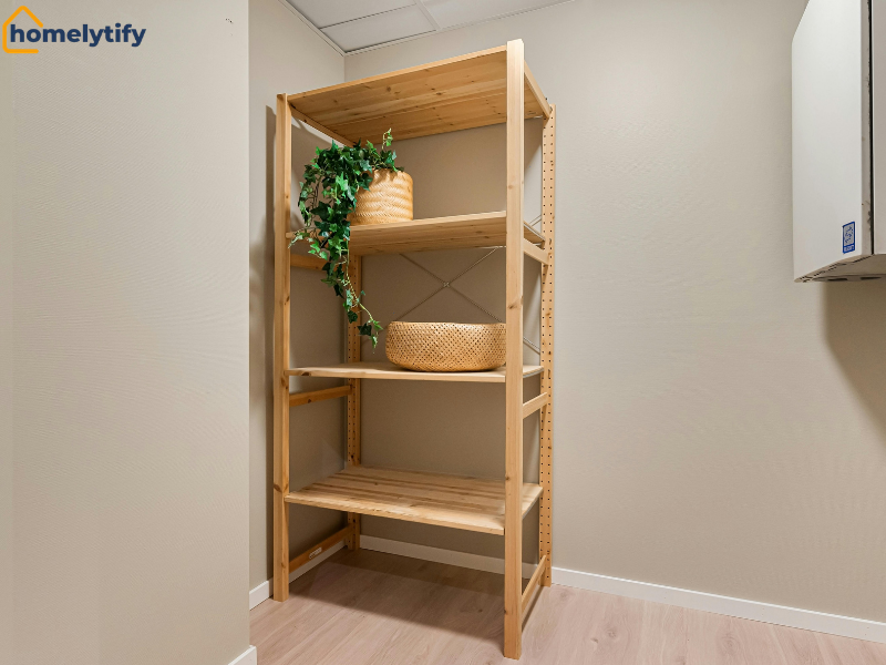 Wooden corner shelves with woven baskets and trailing plant, a simple storage solution for maximizing space in a small room.