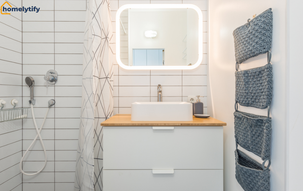 Small bathroom storage with hanging woven baskets, white vanity drawers, and LED mirror