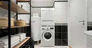 Small laundry room organization ideas featuring black shelving, woven baskets, and a stacked washer-dryer
